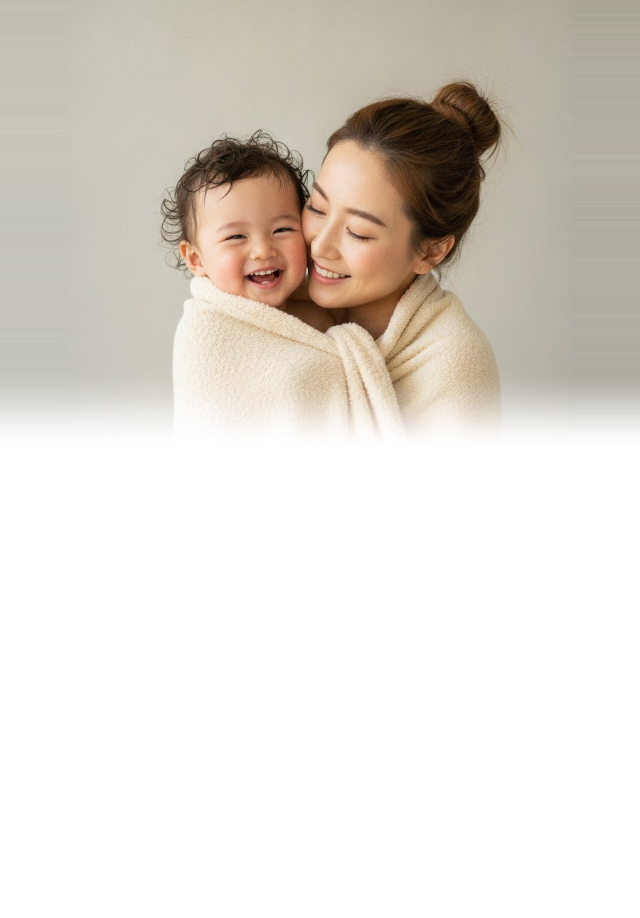 Mum and toddler wrapped in a soft CloudWeave kids towel after a bath