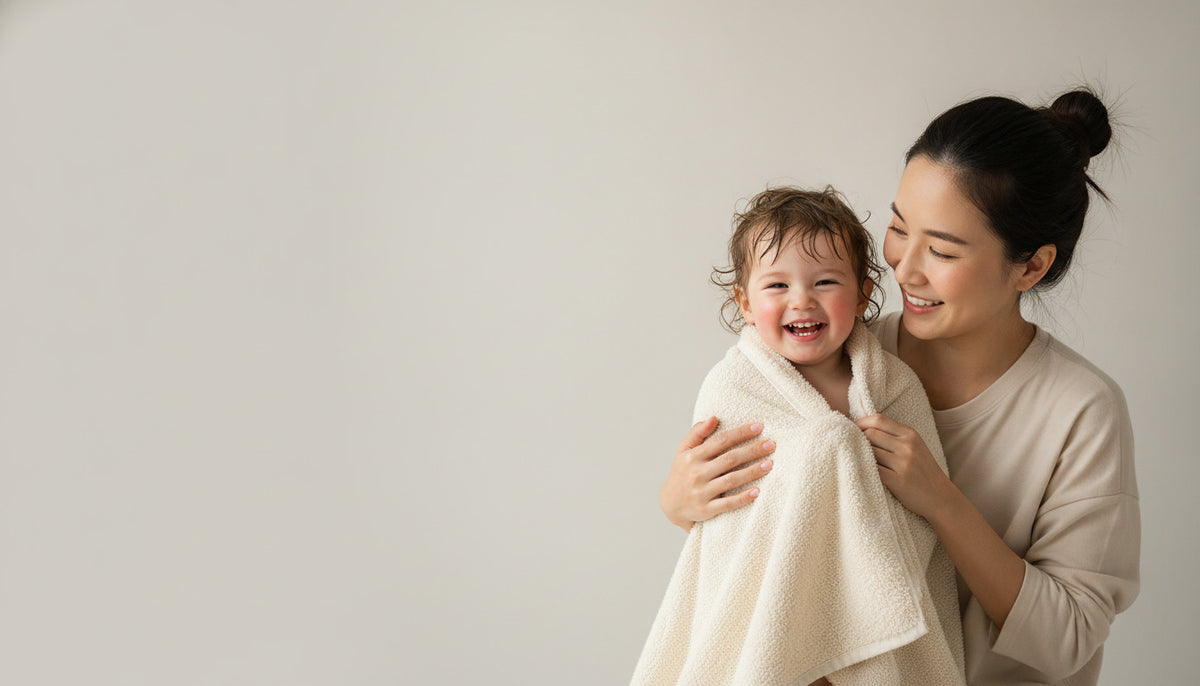 Mum wrapping her toddler in a soft CloudWeave kids towel after a bath