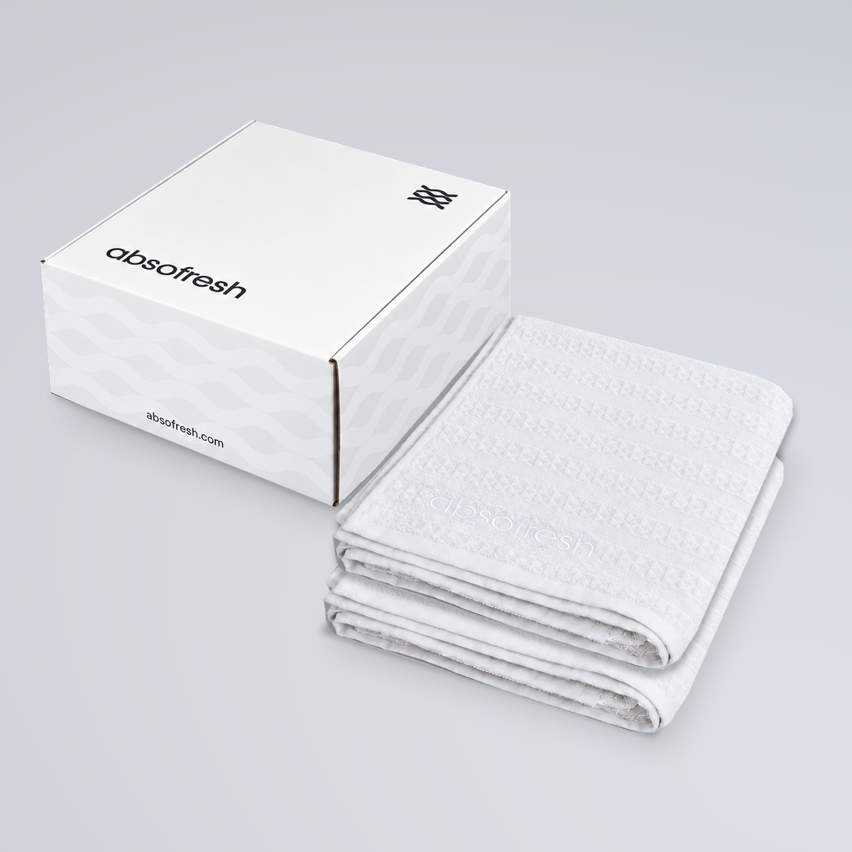 AeroWeave Bath Towel Gift Set with two Pure White towels stacked beside the Absofresh gift box