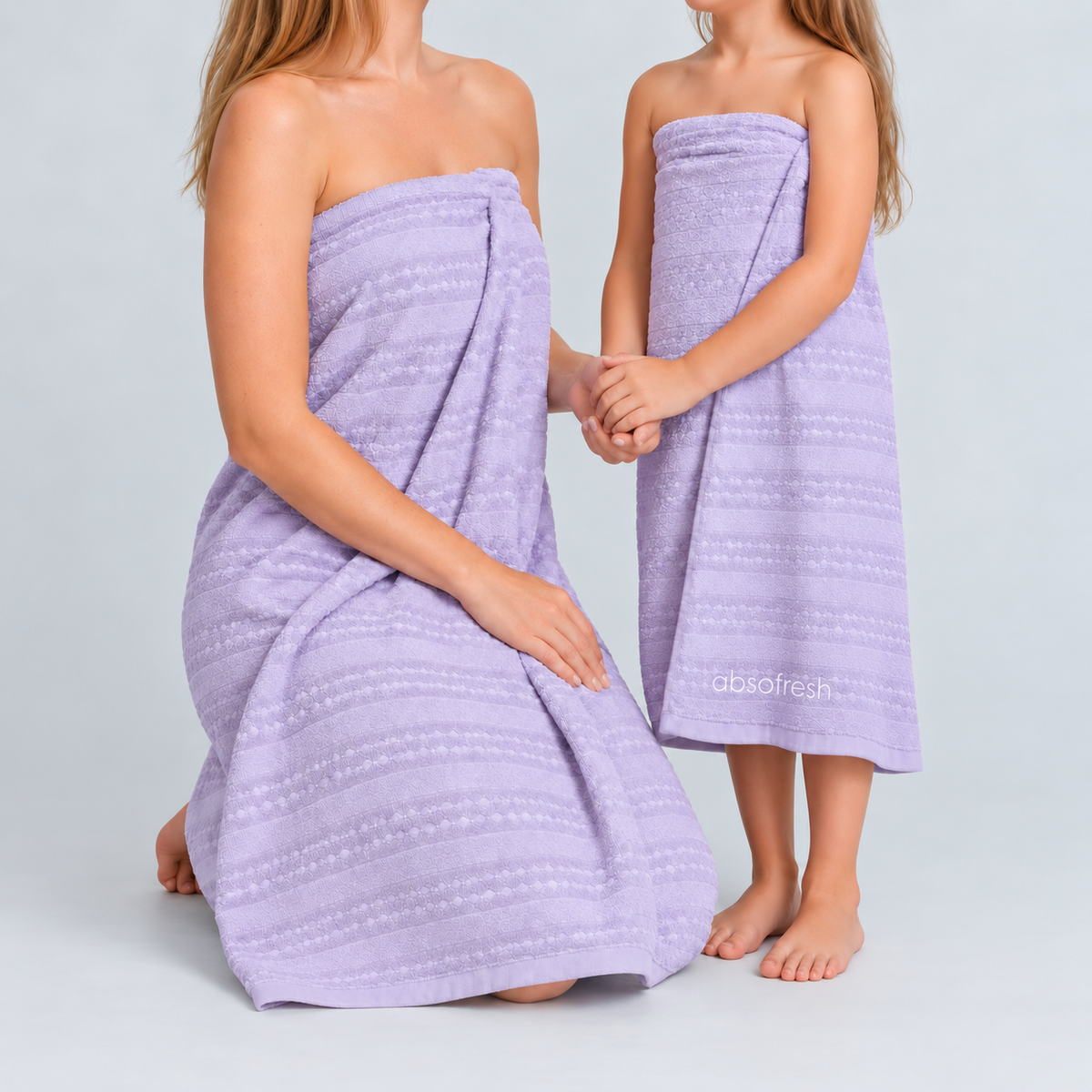 Mother and daughter using lilac purple AeroWeave bath and kids towels