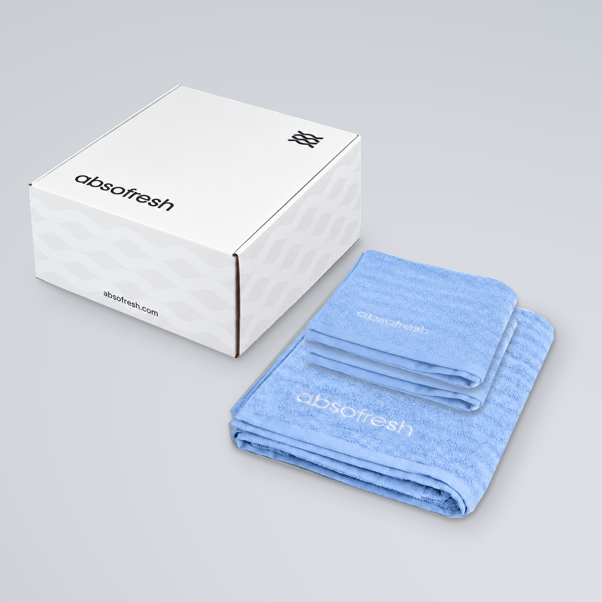 CloudWeave Home Essentials Gift Set with one Sky Blue bath towel beneath two matching hand towels beside the Absofresh gift box
